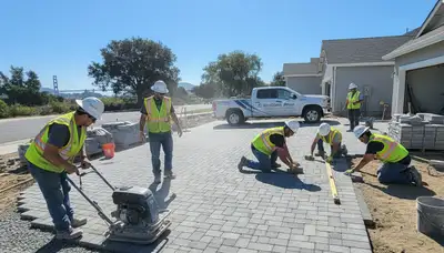 Professional crew installing driveway pavers in Stockton, CA with precise base prep and leveling work